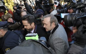 US actor Kevin Spacey wades through a media frenzy as he makes his appearance during his arraignment on January 7, 2019 at the Nantucket District Court, in Nantucket, Massachusetts.