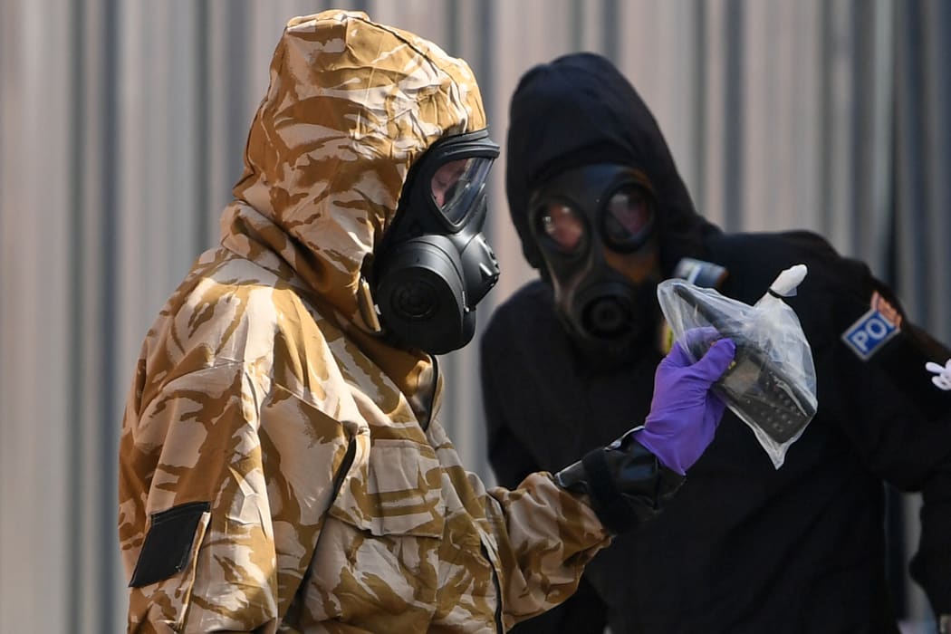 An investigators in protective suits in Rollestone Street on 6 July, 2018 after a man and woman were found unconscious in a novichok attack.