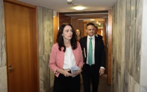 Jacinda Ardern and James Shaw on their way to unveil the zero carbon bill.