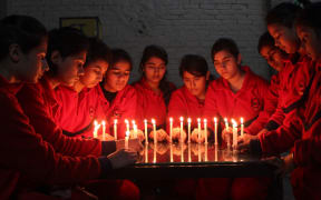 In India, schoolchildren lit candles for the victims.