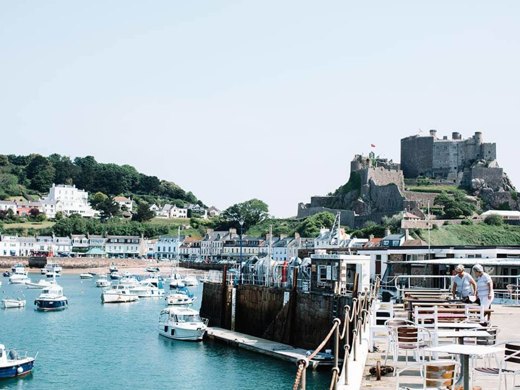The harbour village of  Gorey in Jersey with and the 13th century castle Mont Orgueil.