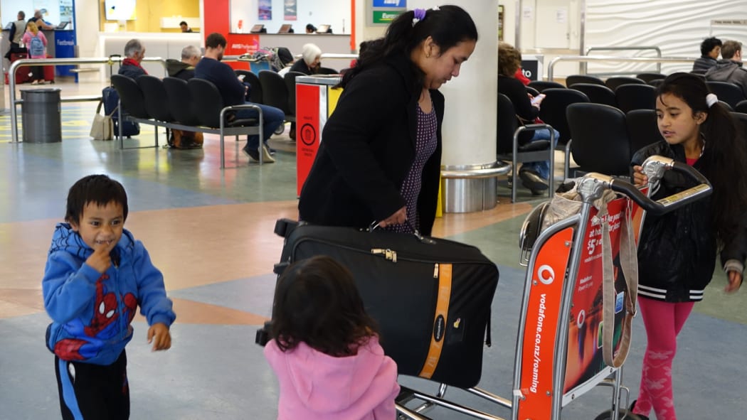 Ioane Teitiota's wife, Angua Erika, with the couple's three children at Auckland International Airport on Wednesday 23 September 2015. The family's application to be considered refugees from the effects of climate change in Kiribati has been declined, and Mr Teitiota is being deported today.