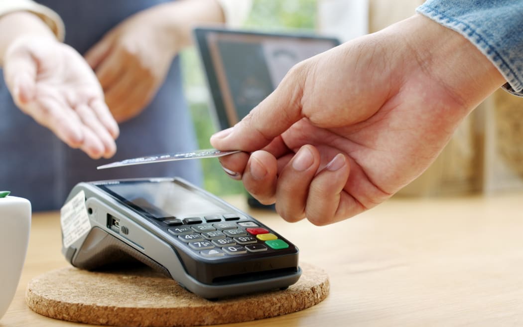 Close-up hand asia woman people work in small sme coffee cafe shop store owner use cashless wifi paywave nfc scan app smart pos reader sale in take out food drink order in urban city life contactless.