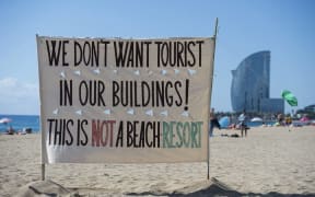 An anti-tourism banner on La Barceloneta beach during a demonstration against "drunken tourism" called by the residents of La Barceloneta neighbourhood in Barcelona, on August 12, 2017.