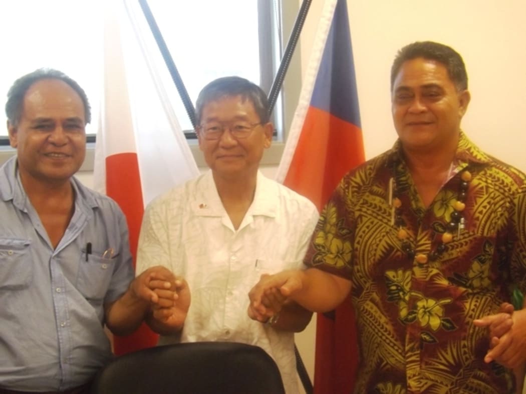 The Japan Ambassador  to Samoa, Kazumasa Shibuta, with village representatives receiving financial assistance.