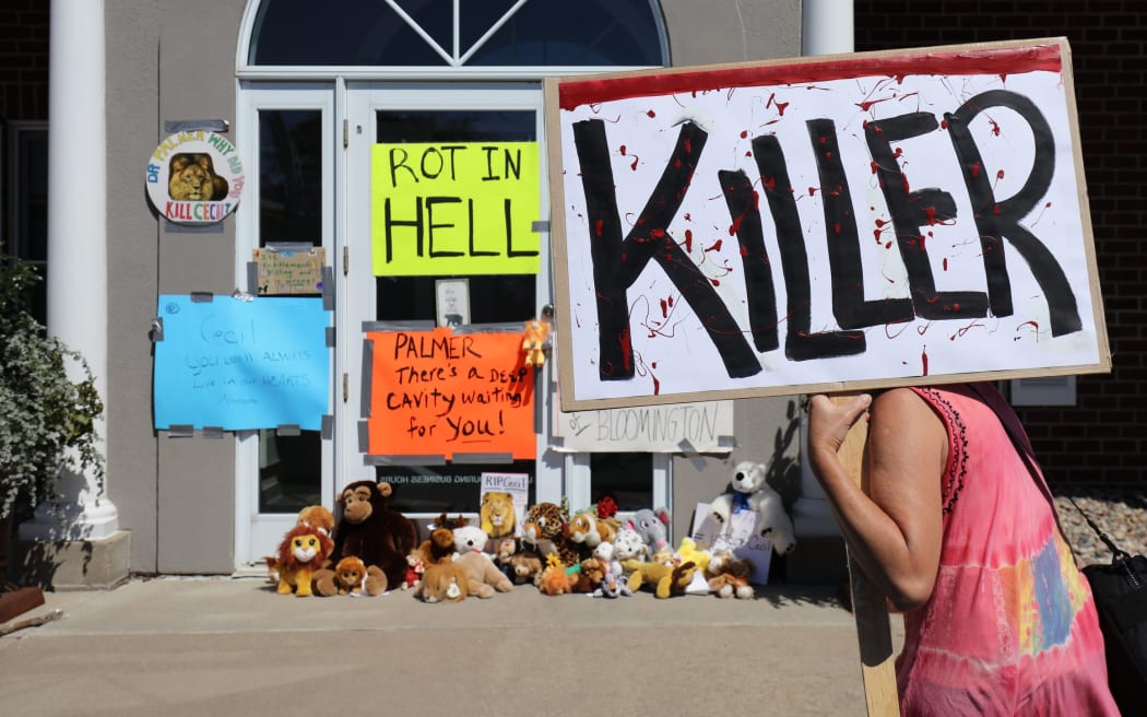 Protesters gathered outside Dr Walter Palmer's clinic in Bloomington, Minnesota.