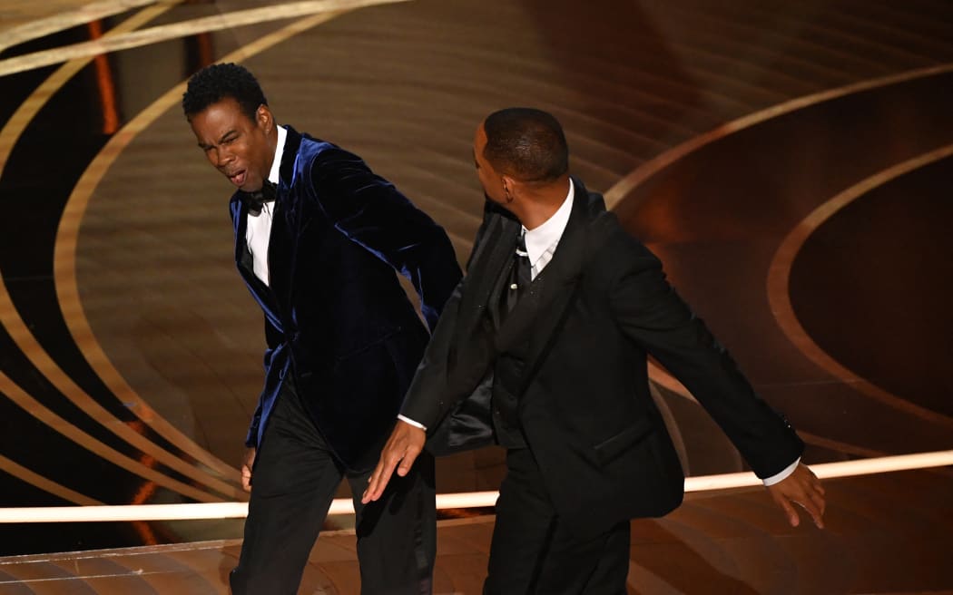 In this file photo taken on March 27, 2022, US actor Will Smith (R) slaps US actor Chris Rock onstage during the 94th Oscars at the Dolby Theatre in Hollywood, California. - Will Smith has posted an emotional new apology for slapping Chris Rock at the Oscars earlier this year, revealing in a lengthy video clip, posted to social media on July 29, 2022, that he has reached out to the comedian who was not yet "ready to talk."