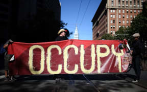 Occupy Wall Street protestors hold a large banner during a demonstration in San Francisco in 2012.