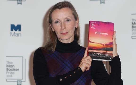 Man Booker Prize winner Anna Burns holds her book 'Milkman'.