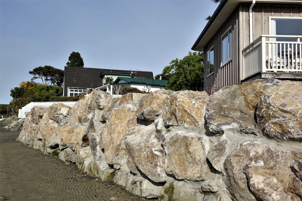 Rock walls protect homes from the sea in Nelson.