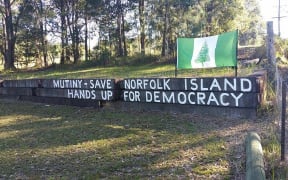Protesters have been hanging up banners and signs around Norfolk Island