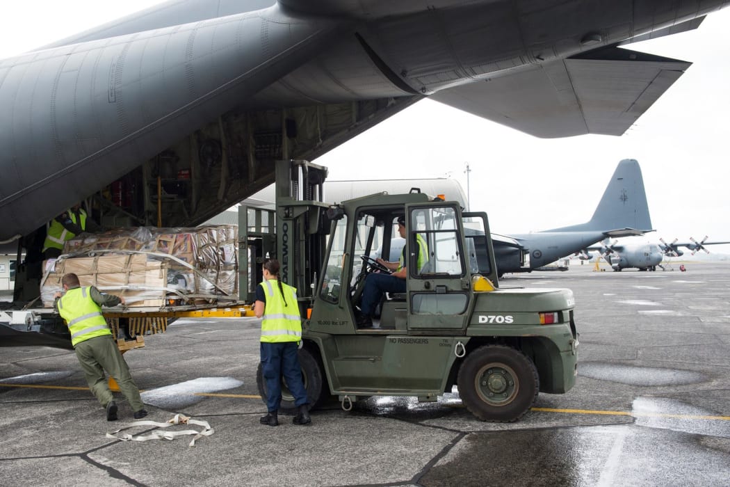 Books being loaded onto a C-130 Hercues.