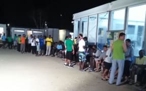 Residents of the Manus Island processing centre queue for food.