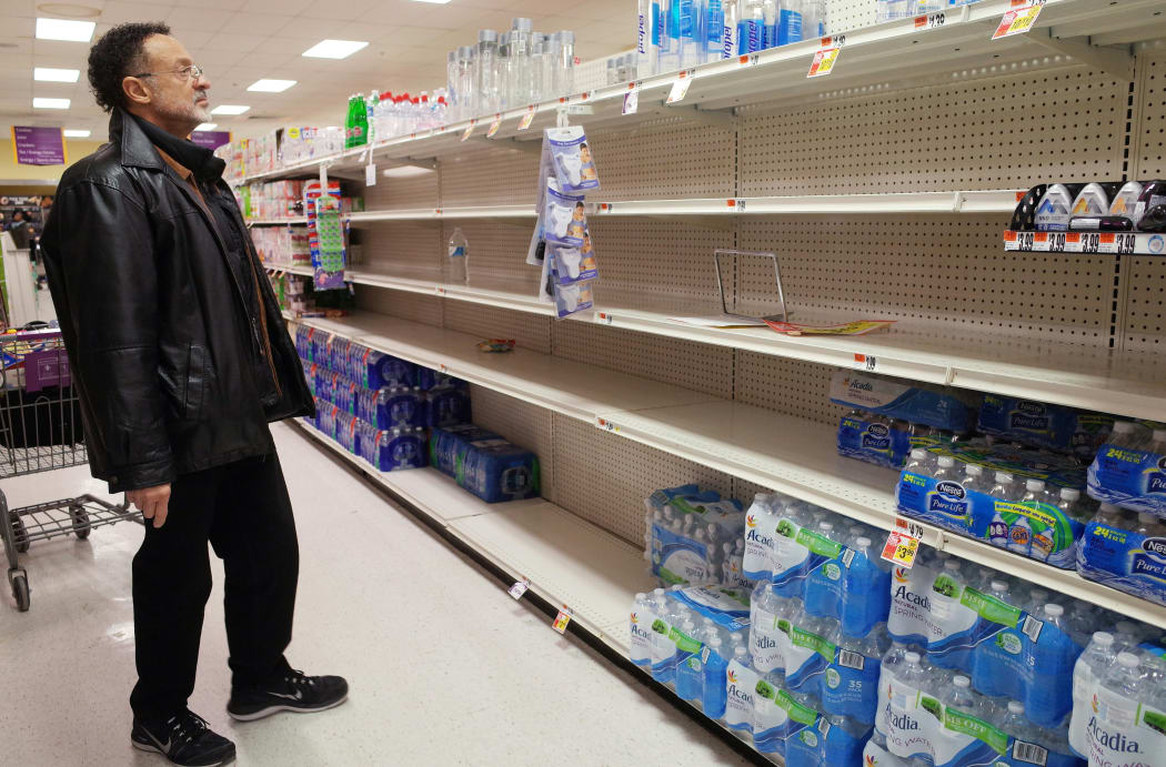 shopper looks at the bottled water section at a supermarket ahead of an expected blizzard.