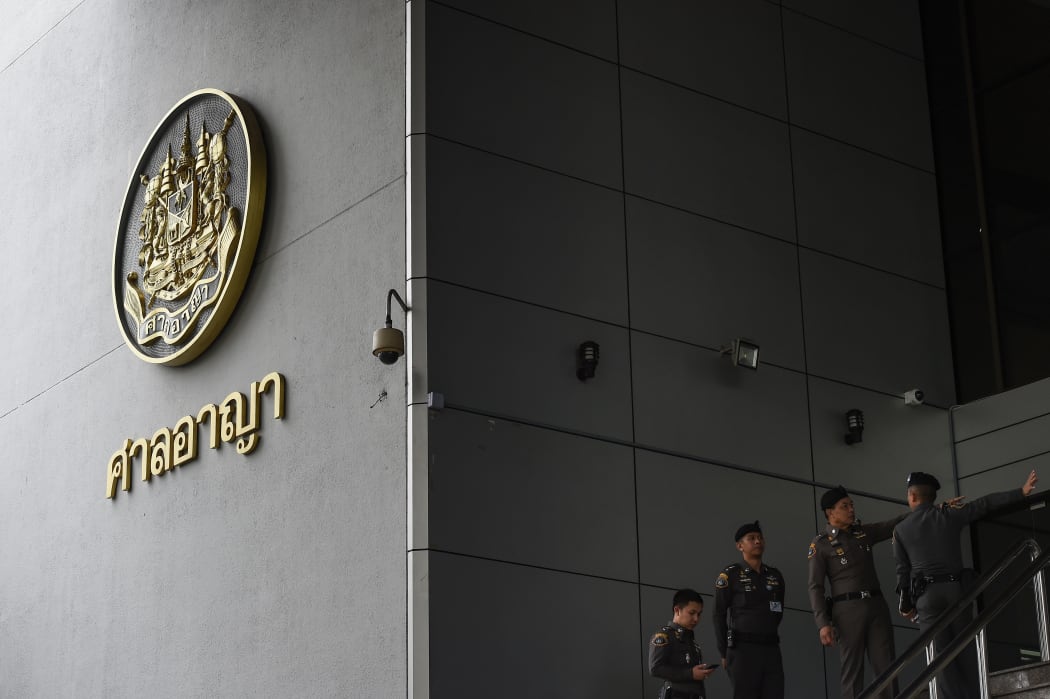 Thai policemen stand guard outside of a criminal court in Bangkok