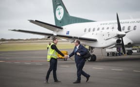 Air Chathams general manager Duane Emeny greets Whanganui MP Chester Borrows on his arrival from Auckland.