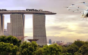 An illustration showing an air taxi heading towards Singapore's Marina Bay Sands.