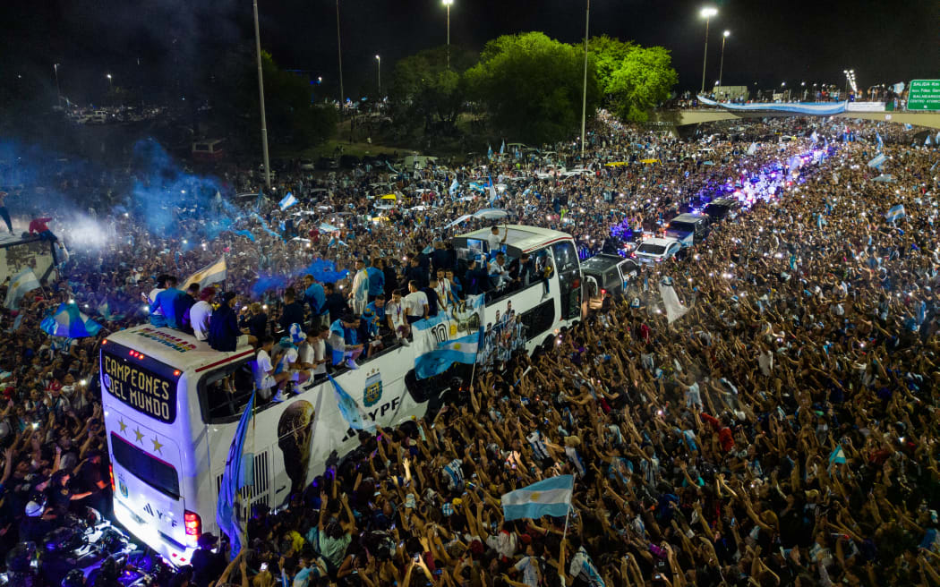 Supporters cheer the homecoming Argentina football team as the players celebrate after winning the Qatar 2022 World Cup tournament, in Ezeiza, Buenos Aires province, Argentina, on 20 December, 2022.