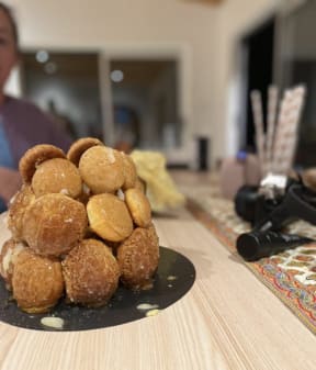 An attempt to make a tower of eclairs called a croquembouche.
