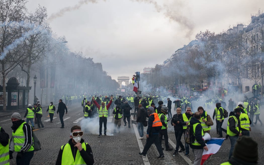 2018 People wearing yellow vests, a symbol of a French drivers' rally against higher fuel prices, gather on the Champs-Elysees, in Paris, France, November 24, 2018.