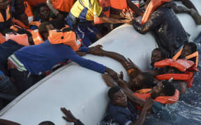 Migrants panic as they fall in the water during a rescue operation by the Topaz Responder ship, run by NGOs.