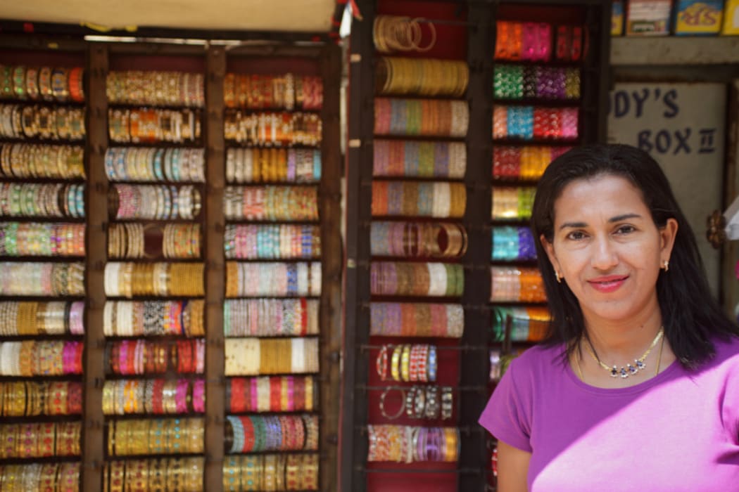 Shobha Narayan in front of a street store.