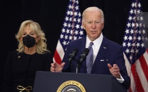 BUFFALO, NEW YORK - MAY 17: With his wife Jill by his side, US President Joe Biden delivers remarks to guests, most of whom lost a family member in the Tops market shooting, at the Delavan Grider Community Center on May 17, 2022 in Buffalo, New York. The president and first lady placed flowers at a memorial outside of the Tops market and met with families of victims prior to addressing the guests at the community center. A gunman opened fire at the Tops market on Saturday killing ten people and wounding another three. The attack was believed to be motivated by racial hatred.   Scott Olson/Getty Images/AFP (Photo by SCOTT OLSON / GETTY IMAGES NORTH AMERICA / Getty Images via AFP)
