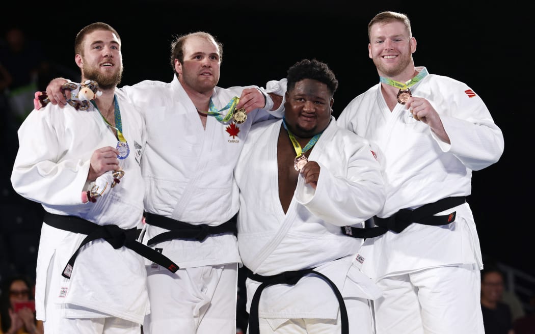 Gold medallist Marc Deschenes (2nd L) of Canada stands on the podium with silver medallist New Zealand's Kody Andrews and bronze medallists Sebastien Perrinne of Mauritius (2nd R) and Australia's Liam Park (R) during the medal presentation ceremony for the men's +100kg final judo match on day six of the Commonwealth Games in Birmingham, central England, on 3 August, 2022.