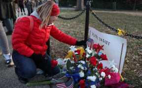 WASHINGTON, DC - JANUARY 07: Melody Black, from Minnesota, becomes emotional as she visits a memorial setup near the U.S. Capitol Building for Ashli Babbitt who was killed in the building after a pro-Trump mob broke in on January 07, 2021 in Washington, DC.