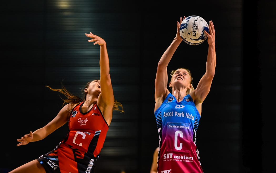 Shannon Saunders of the Steel takes a ball from Kimiora Poi of the Tactix.