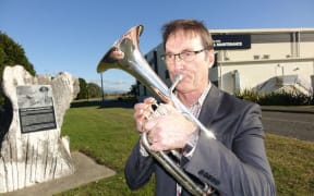 Nelson brass musician Mike Ford practises tenor horn near the airport walkway during his tea breaks at work.