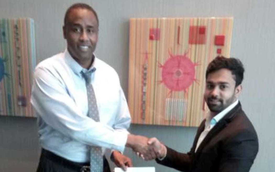 The founder of Instacharge, Douglas Stewart, left, meets with businessman Gaurangbhai Patel in Fiji last week.