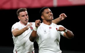 England rugby players George Ford (L) and Manu Tuilagi (R) celebrate.