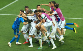 Russian players mob goalkeeper Igor Akinfeev after he saves the final penalty and wins them the match.