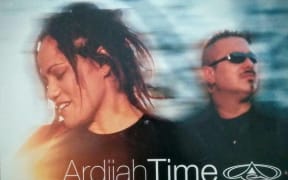 Cover image of Ardijah's album Time. Photo of two people in motion, outdoors.