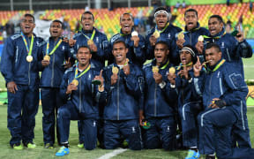 Gold medallists Fiji celebrate during the men’s rugby sevens medal ceremony during the Rio 2016 Olympic Games at Deodoro Stadium in Rio de Janeiro onAugust 11, 2016.