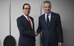 French Finance and Economy Minister Bruno Le Maire (R) shakes hands with US Secretary of the Treasury Steven Mnuchin during a bilateral meeting in Buenos Aires, on July 21, 2018, in the framework of the G20 meeting.