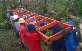 Villagers with the portable sawmill being used to mill timber for the post cyclone rebuild on Koro, Fiji