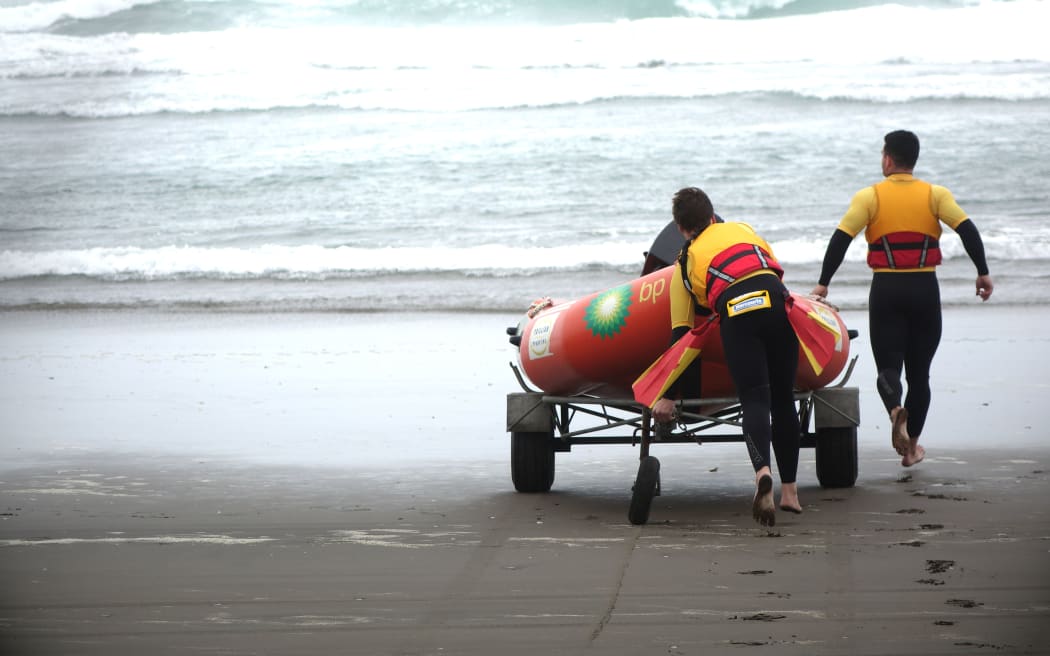 Surf Life Saving lifeguards test out a rescue boat at Muriwai Beach, Auckland.