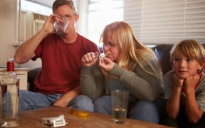 A family with mother taking drugs and father drinking.
