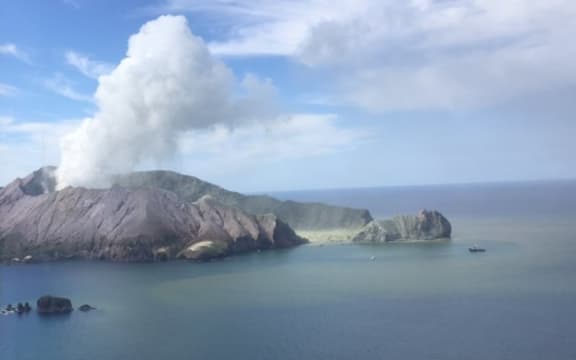 A volcano with a large plume of ash.