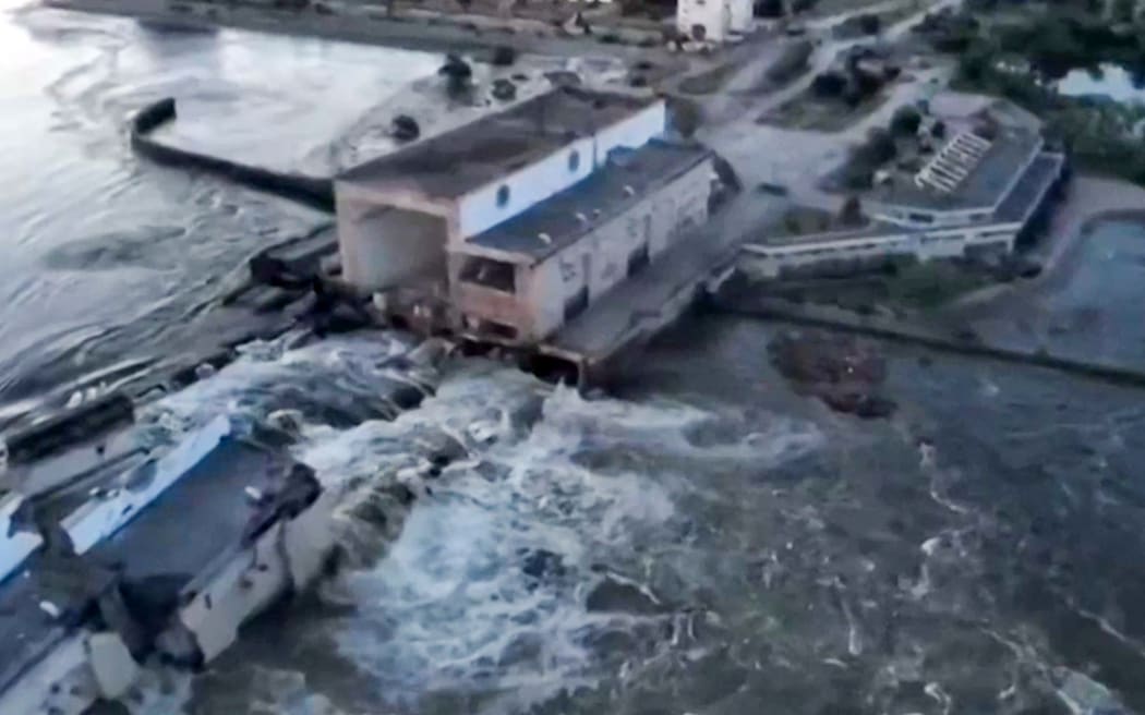 This screen grab from a video posted on Ukraine's President Volodymyr Zelensky's Twitter account on June 6, 2023 shows an aerial view of the dam of the Kakhovka Hydroelectric Power Station after it was partially destroyed.