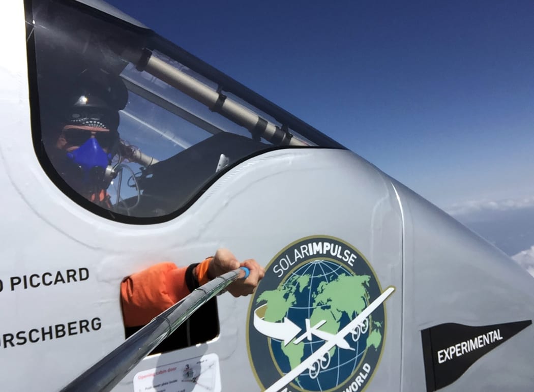 Bertrand Piccard takes a photo using a selfie stick during the flight from Chongqing to Nanjing.