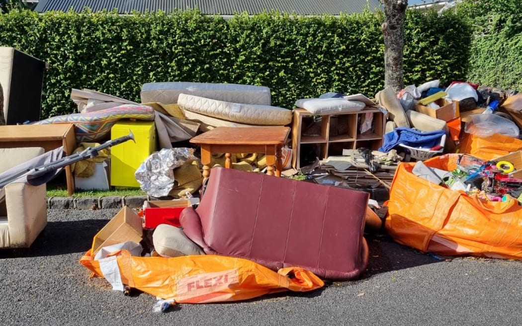 Auckland flooding - piles of rubbish on Shackleton Road in Mt Eden