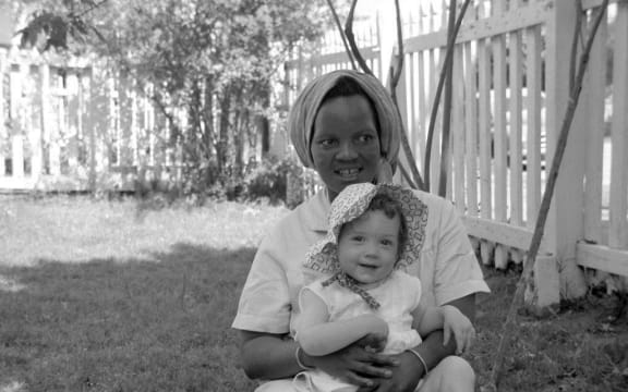 Margaret, Marshal Walker's maid in South Africa, holding one of Marshall's daughters.