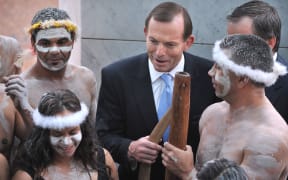 Australian Prime Minister Tony Abbott talking to an Aboriginal performer at the opening of the 44th Parliament in Canberra last year.