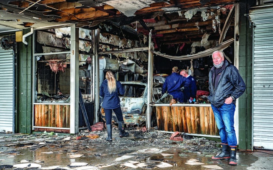 Malcolm Campbell stands in front of his store, Campbell's Butchery, after a ram raid caused it to be gutted by fire in October last year.