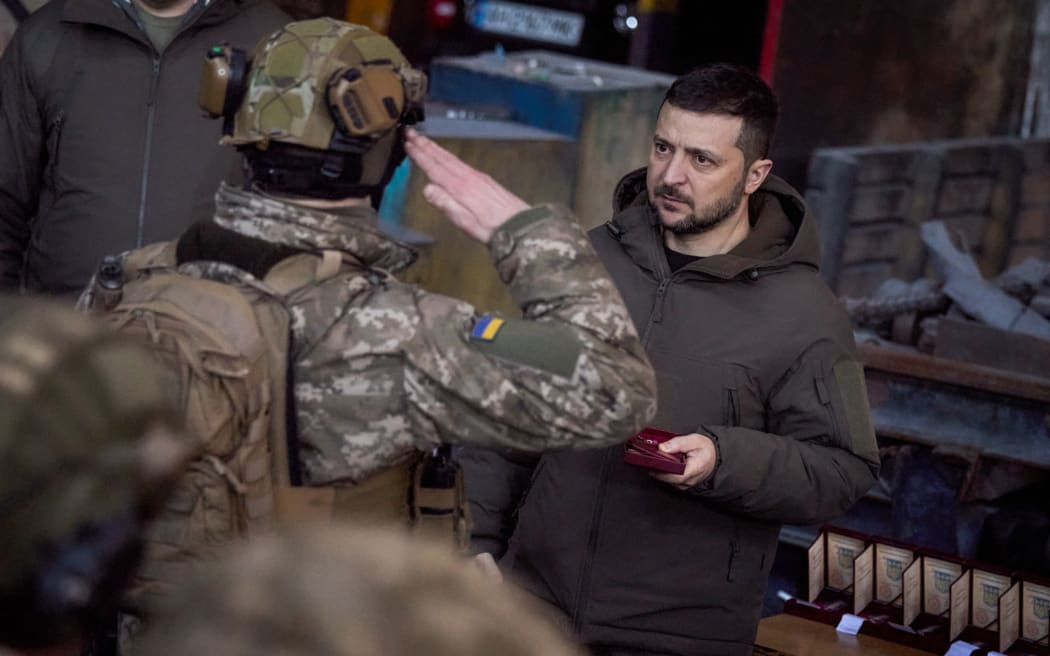 Ukraine President Volodymyr Zelensky (right) hands out the State Award to a soldier during a medal giving ceremony to Ukrainian servicemen who have been holding back a fierce and months-long Russian military campaign for the city, as part of Zelensky's visit in the eastern frontline city of Bakhmut, now the epicentre of fighting in Russia's nearly 10-month invasion of Ukraine.