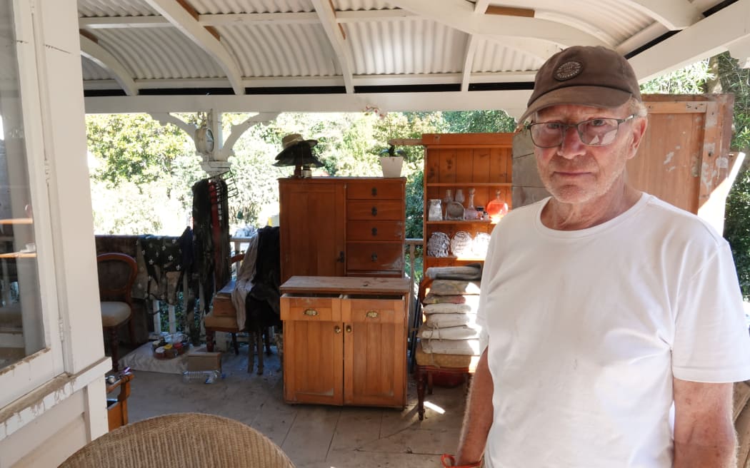 Olly Midgley collects belongings from Puketapu's house.