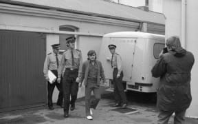Dean Wickliffe is led away by police after being convicted of murder in May 1972